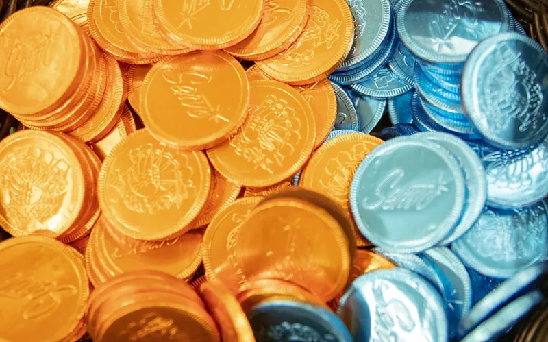 Chocolate candy rounds wrapped in orange and blue foil