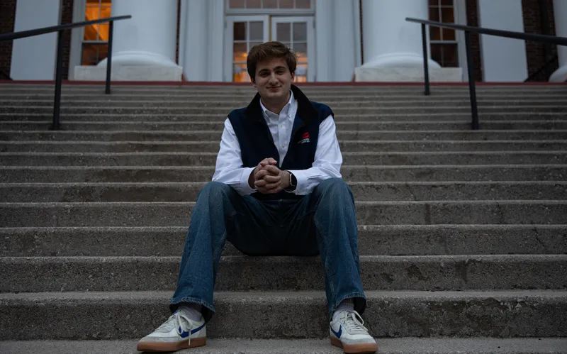 male alum sitting on concrete steps