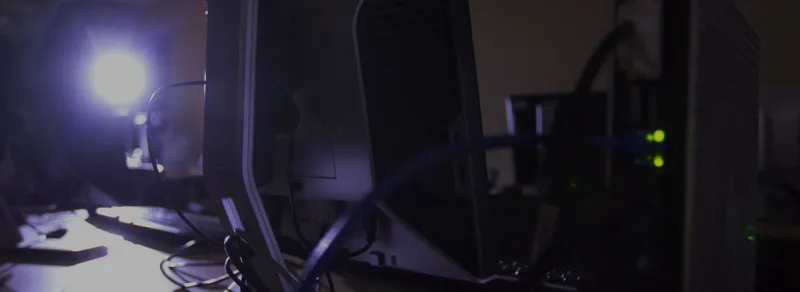 still of back of computer display in back-lit room